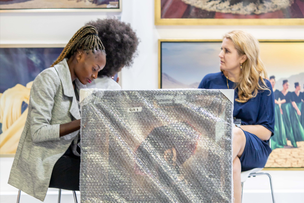 Exhibitors preparing artwork for display at World Art Dubai in Dubai