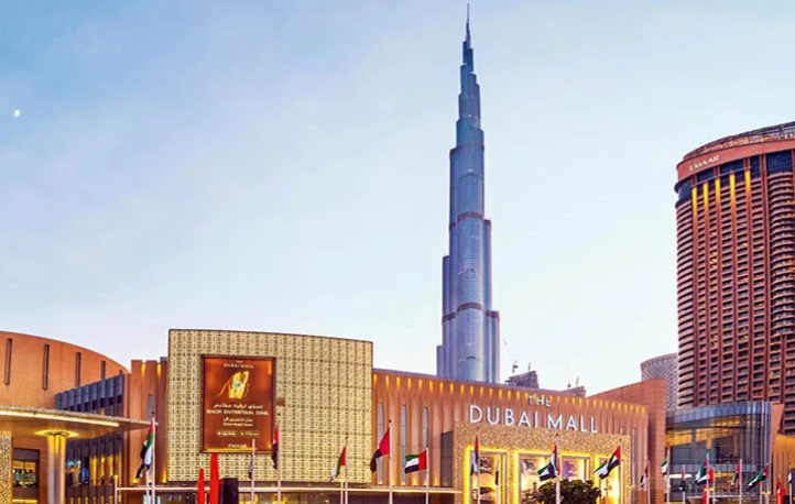 Exhibitor showcasing vibrant abstract paintings at World Art Dubai art fair